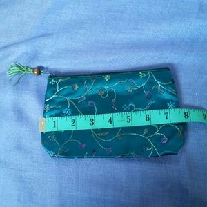 Green satin embroidered cosmetic purse.